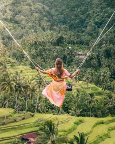 Victoria i gynge ud over ris-landskab på Bali